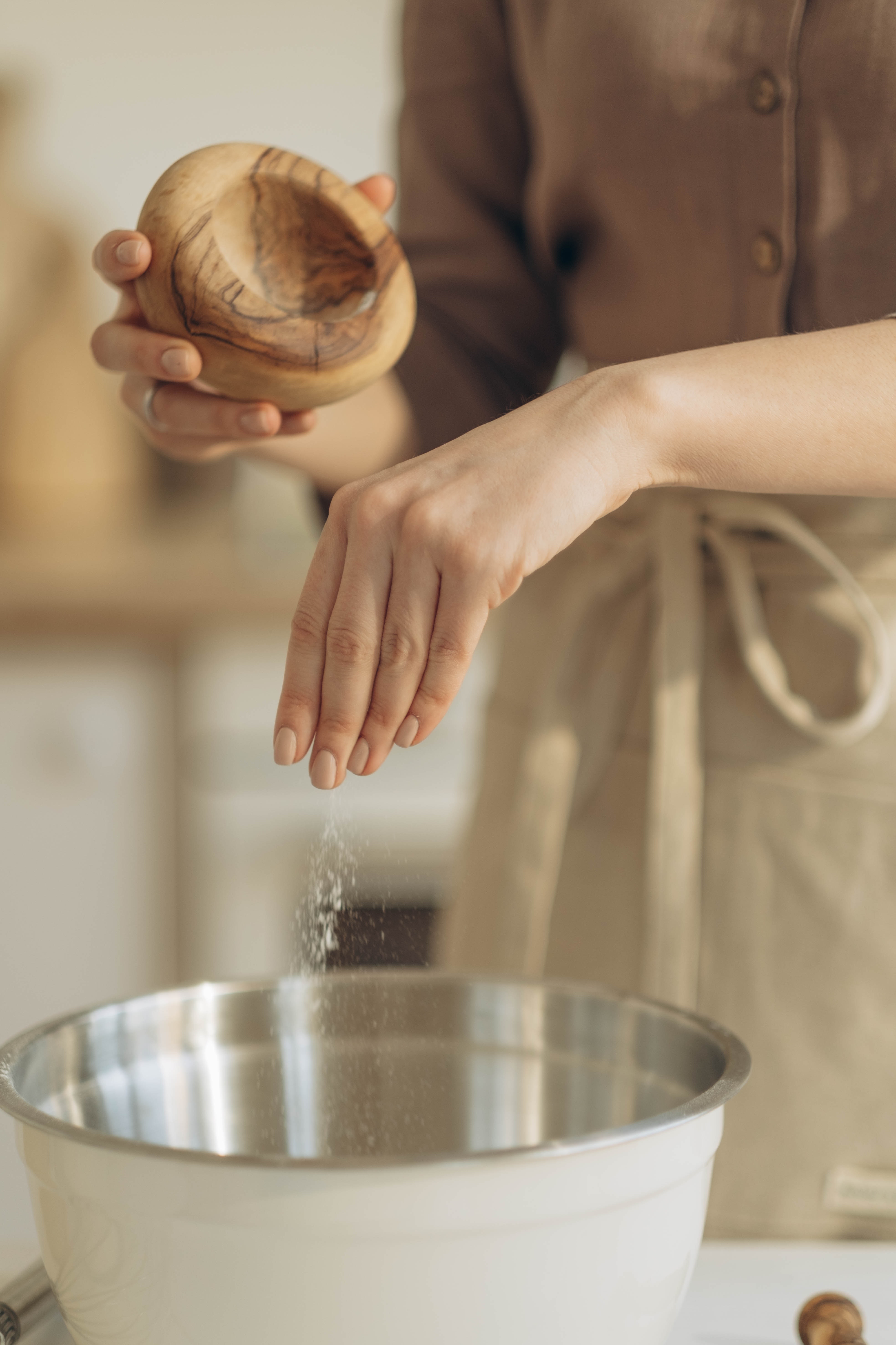 Person Pouring Salt in Bowl